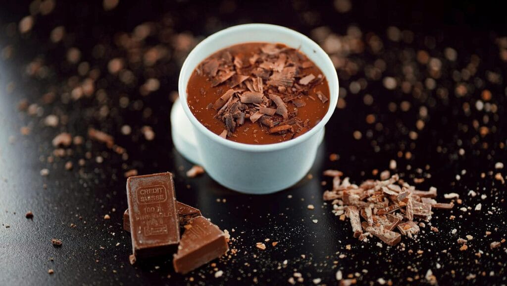Chocolate dessert with gold-themed chocolate bar, symbolizing premium cocoa and specialty agricultural value