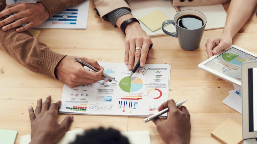 ERP team analyzing business data with charts and graphs during a strategy meeting