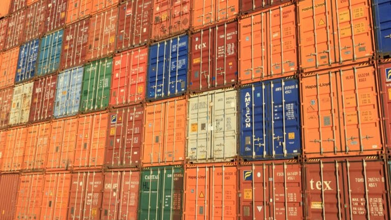 Stacked shipping containers in various colors, symbolizing Vietnam’s multi-tier supplier network and logistics infrastructure