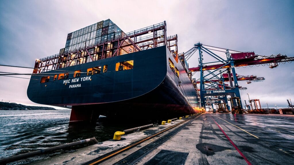 Container ship at port with stacked cargo, symbolizing Vietnam’s global expansion of artisanal and craft industries