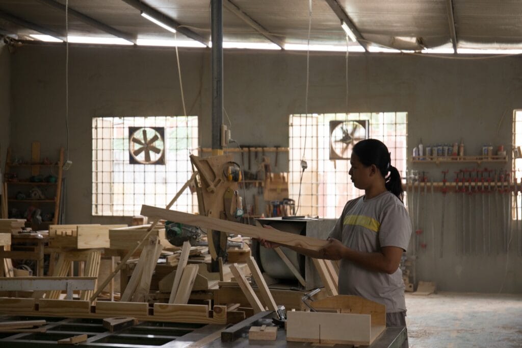 Vietnam furniture workshop, carpenter finishing wood